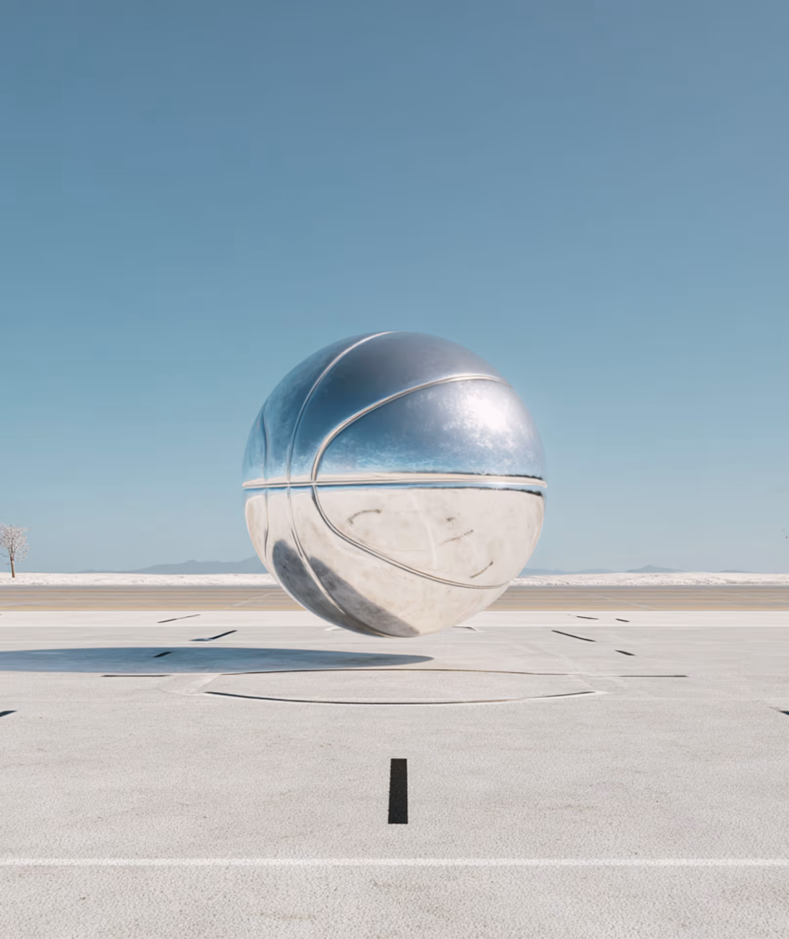 Metallic silver basketball hovering above a court under a clear blue sky.