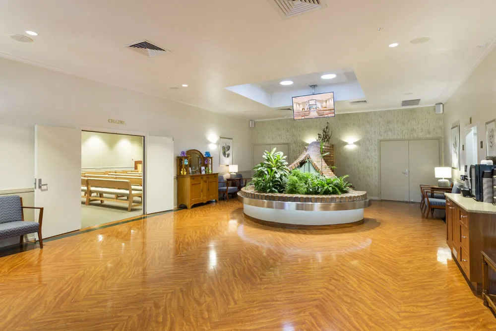 Spacious foyer with a large circular plant feature.
