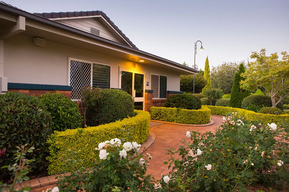 Exterior view of a building with well-kept gardens.