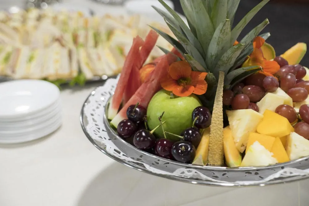 Platter of fresh fruit, including pineapple and grapes.