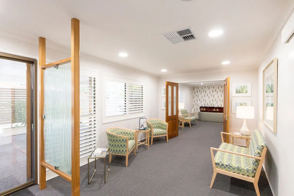 Hallway leading to lounge areas, bright and inviting.