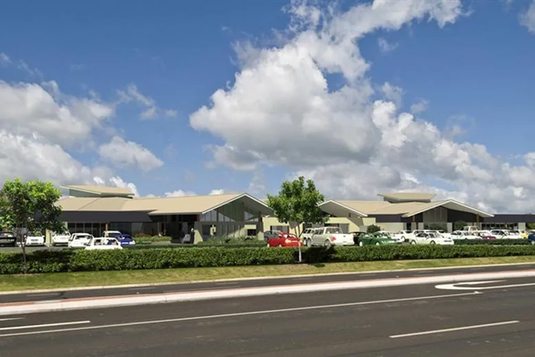 Highway view approaching modern building complex.