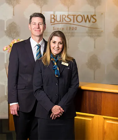 Two Burstows funeral home staff standing by reception.