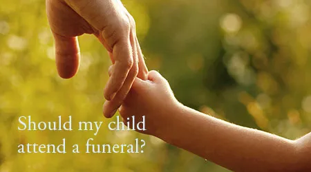 A parent's hand holding a child's hand. Text: "Should my child attend a funeral?"