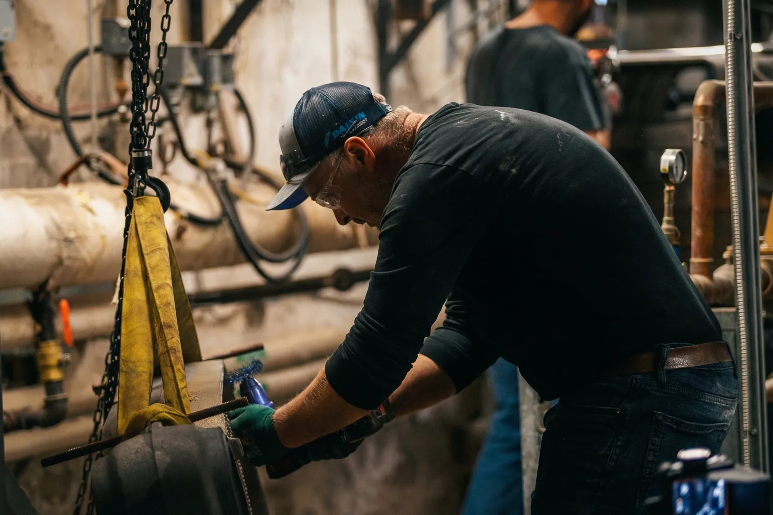 Thor Plumbing & Heating technician working on pipe installation with power tool
