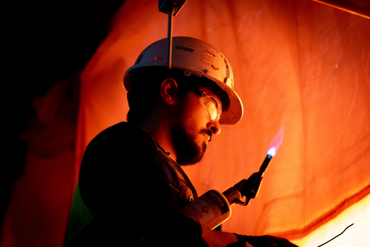 Thor Plumbing technician using torch for soldering copper pipe work