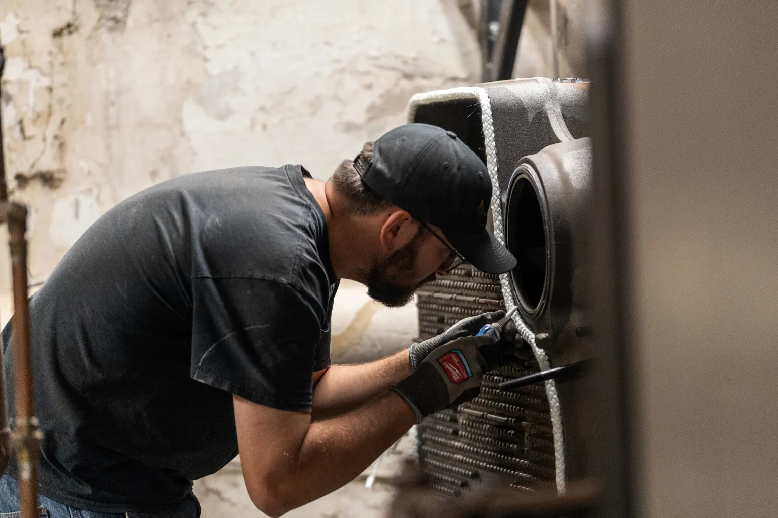 Thor Plumbing & Heating technician performing HVAC unit maintenance