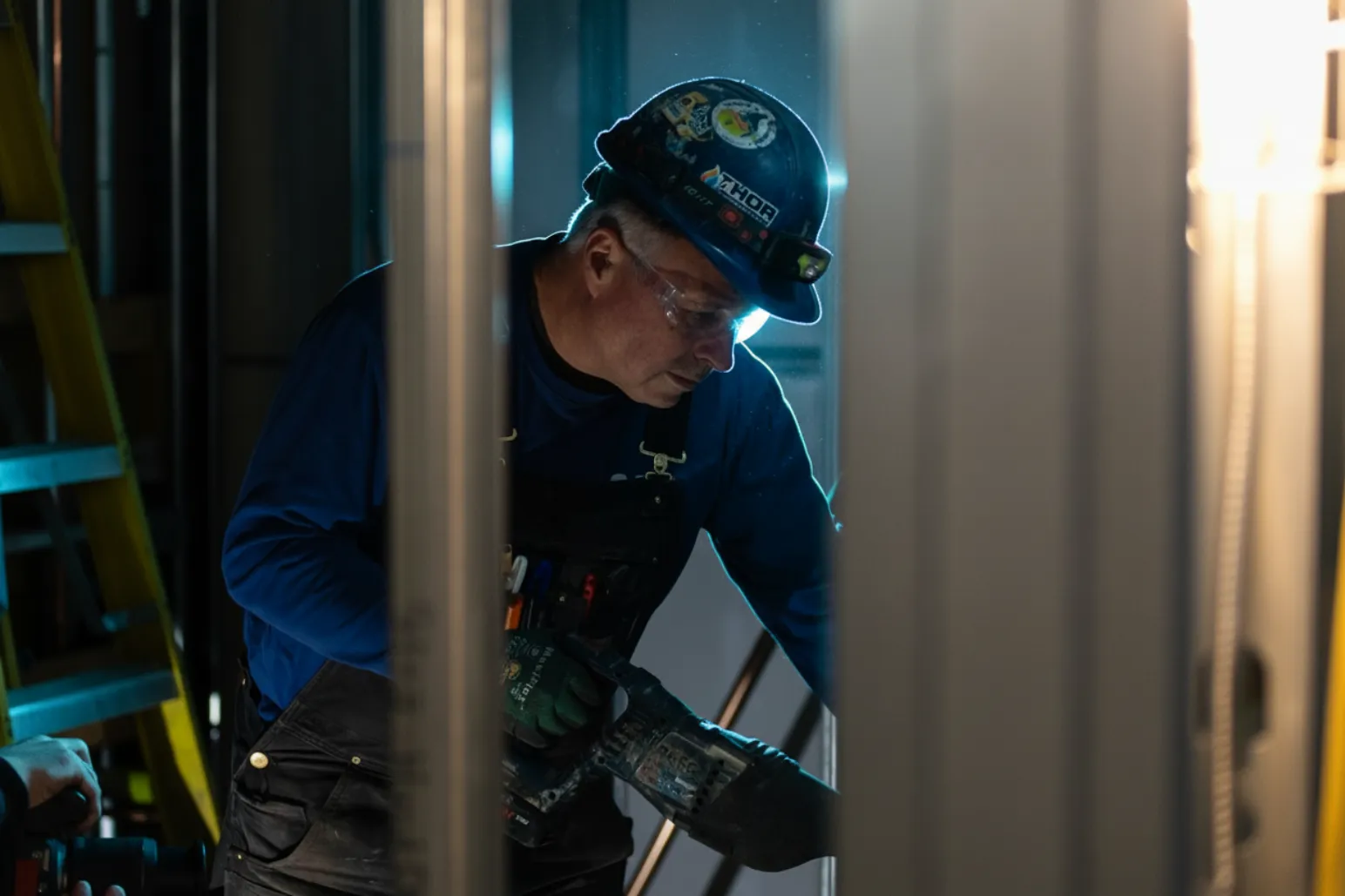 Thor Plumbing & Heating employee wearing hard hat with company stickers