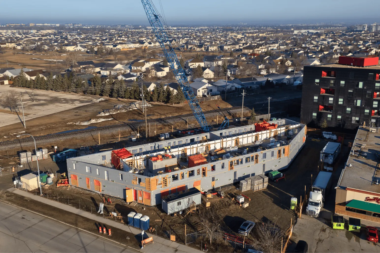 Modular construction building with blue crane aerial view Winnipeg