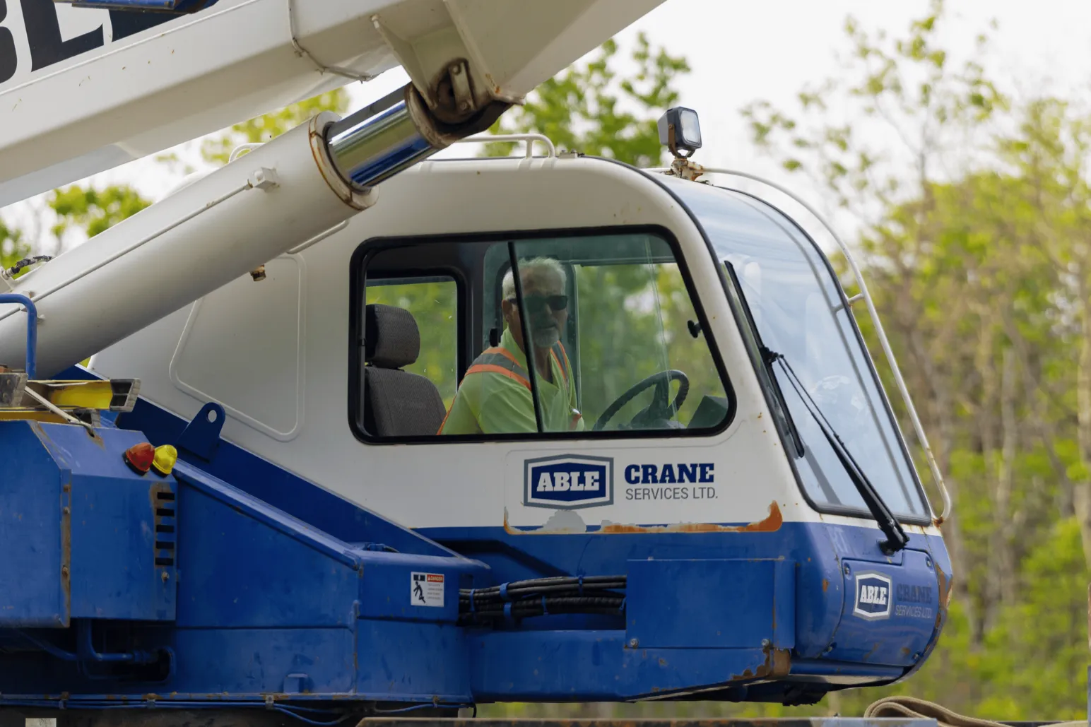 Able Crane Services Ltd branded crane cab with operator during sculpture installation
