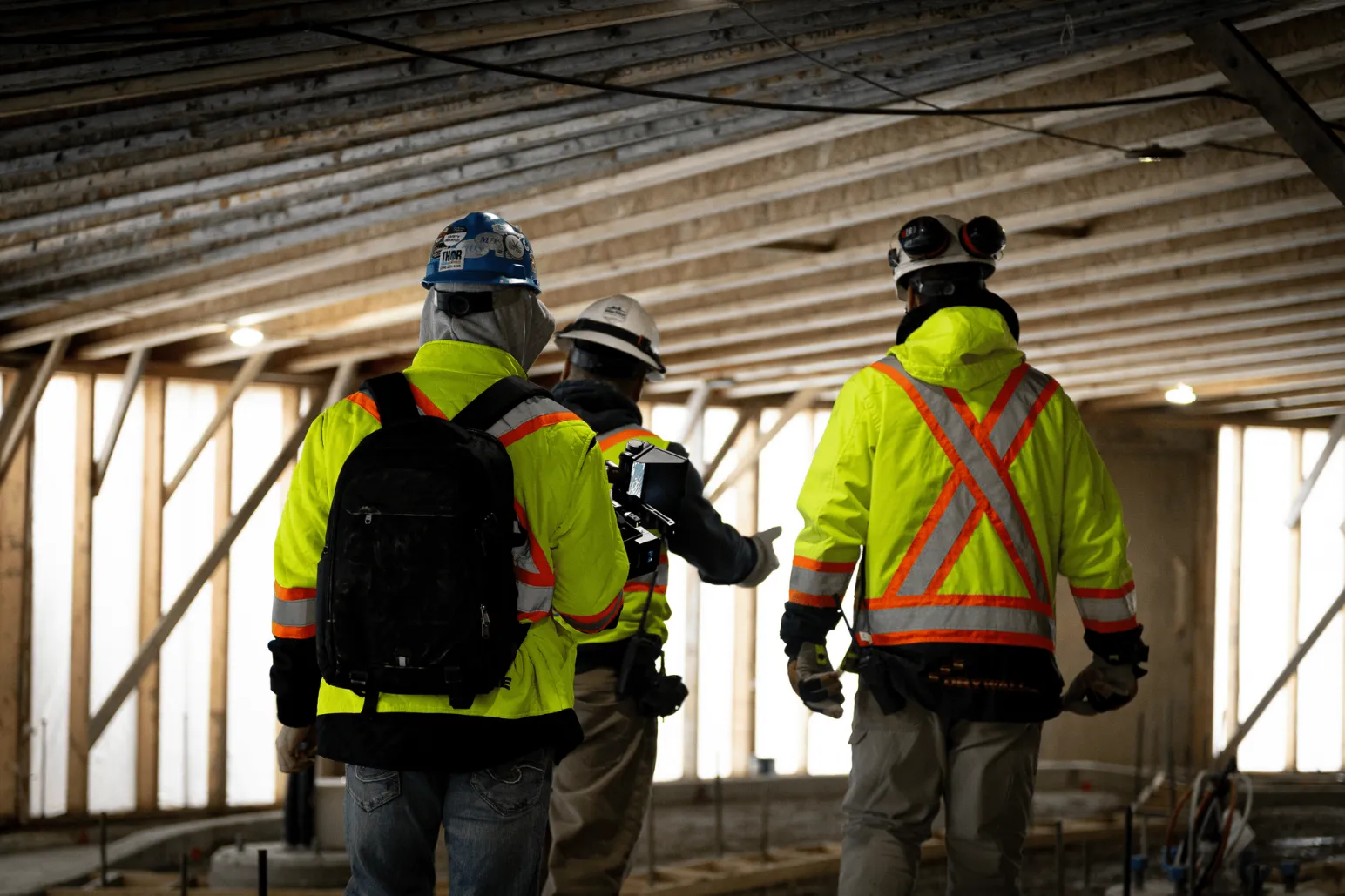 Construction crew walking through underground tunnel at Portage and Main project