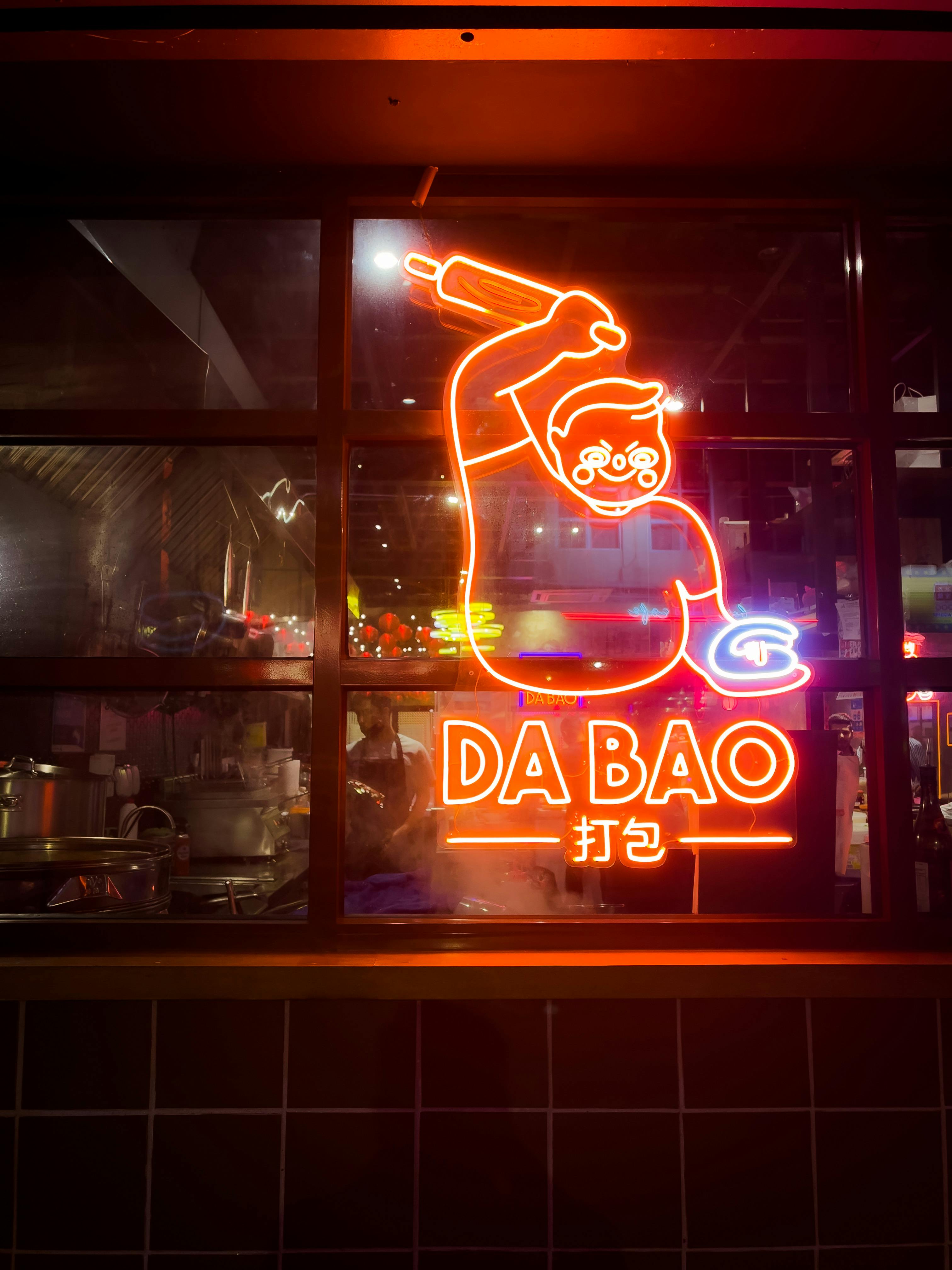 Illuminated Neon Sign on Restaurant Window