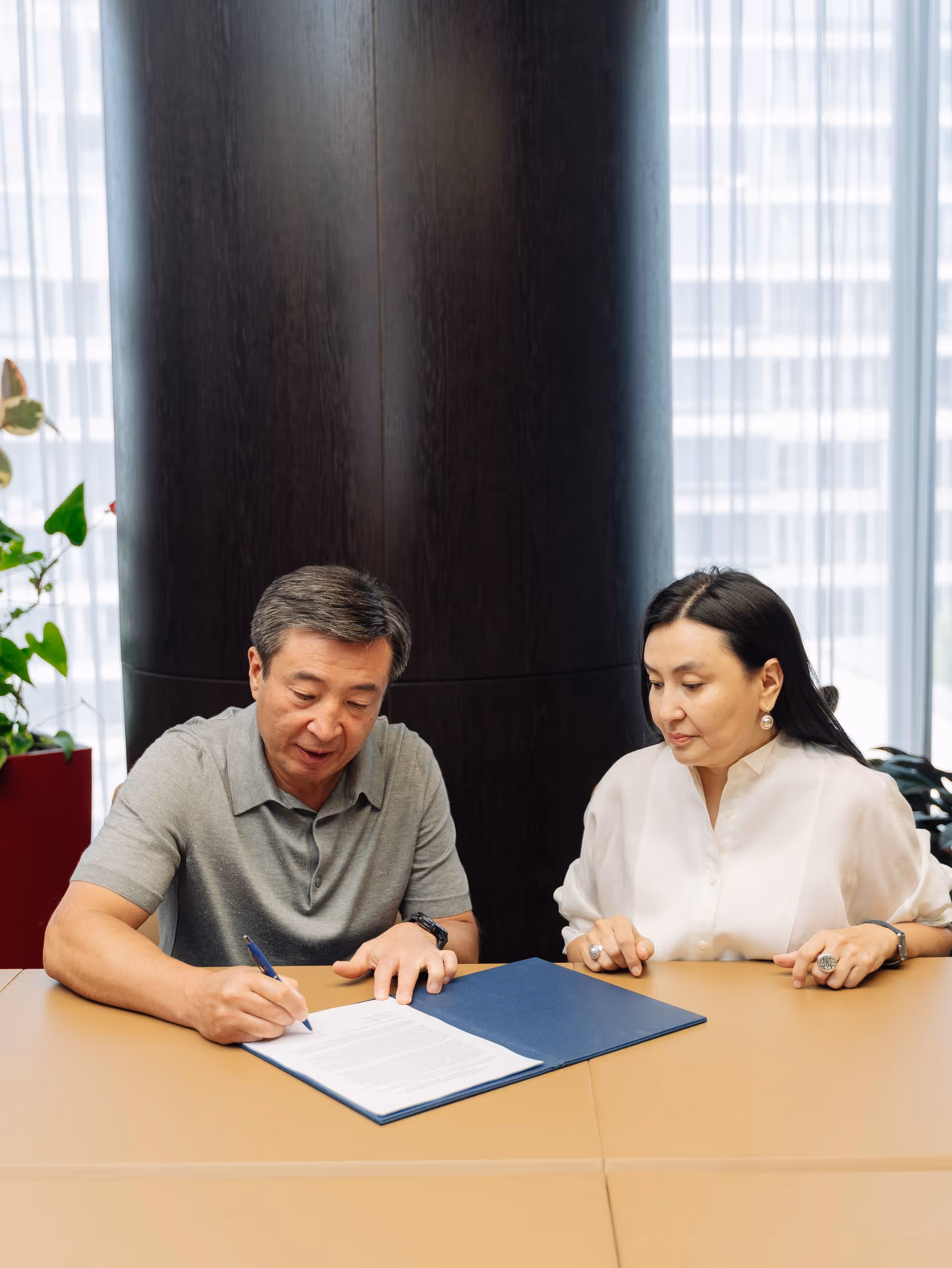 Two founders signing a document