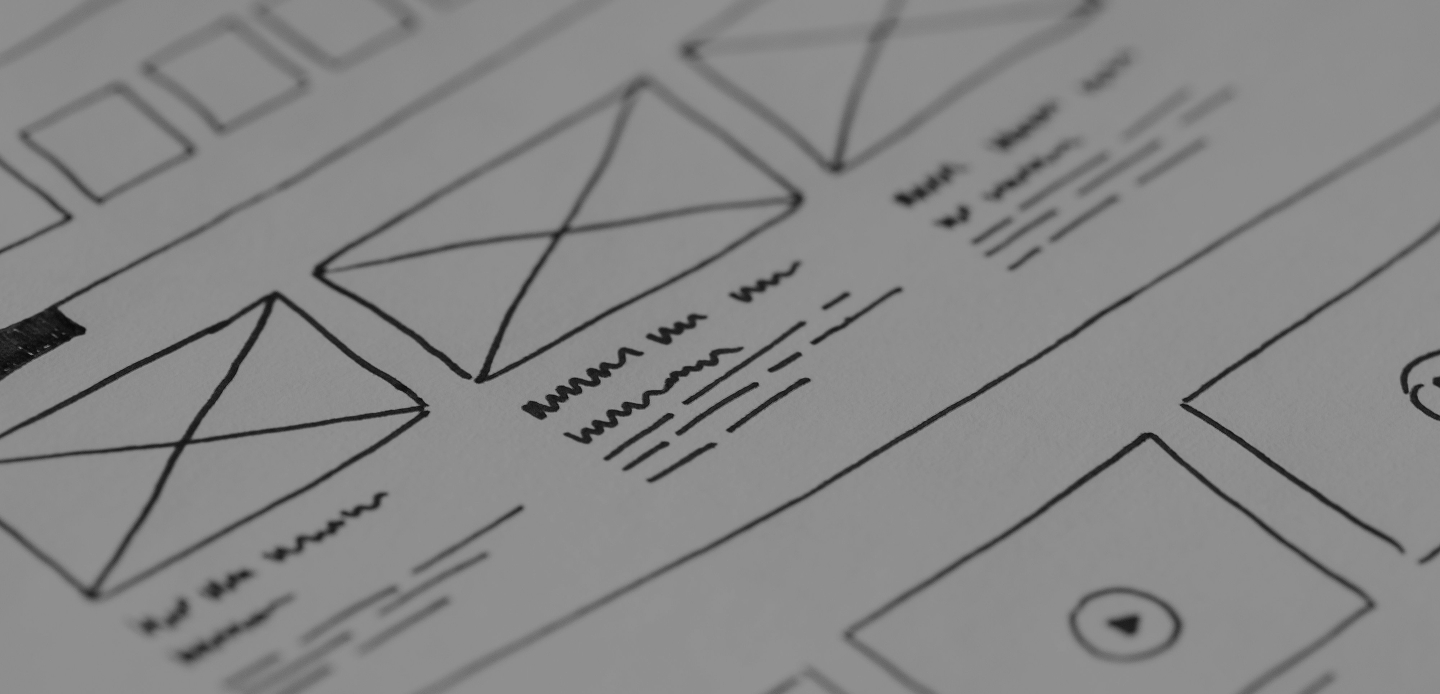 Schéma filaire de site web avec cadres pour images, icônes de lecture et texte factice manuscrit.