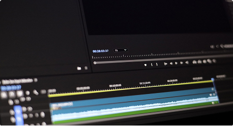 Écran montrant une timeline de montage vidéo avec des pistes audio et des contrôles de lecture visibles.