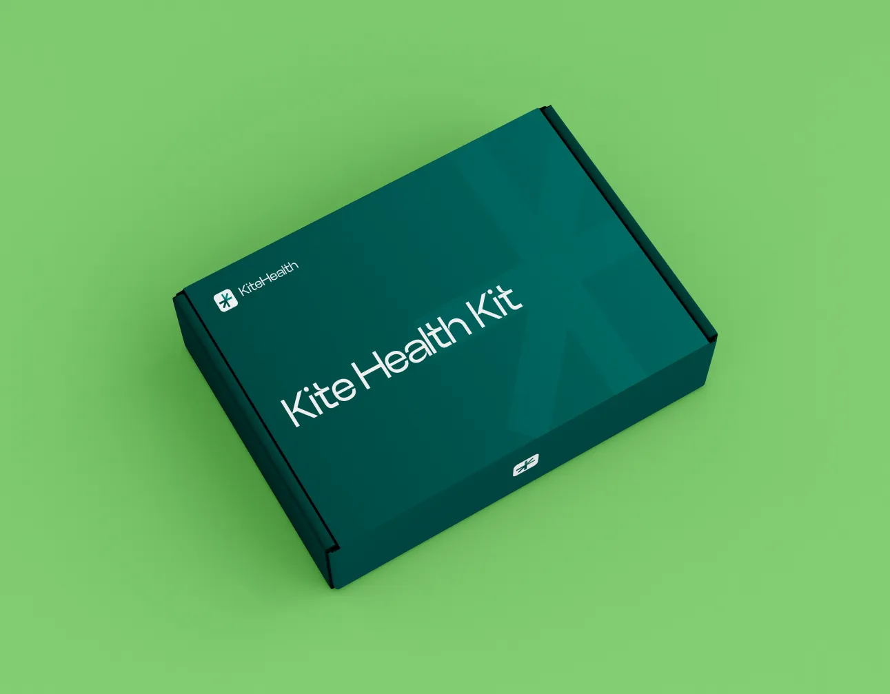 Closed dark green Kite Health Kit box on a light green surface.