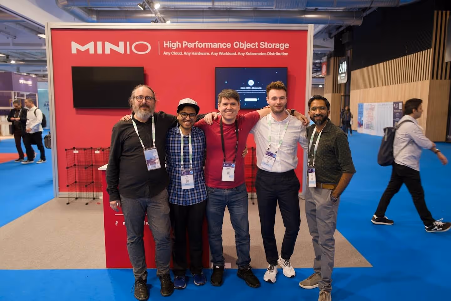 MinIO team posing at tech conference with High Performance Object Storage booth