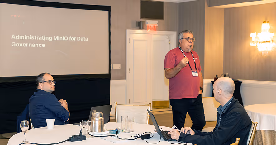 Presenter speaking at data governance workshop with slide and attentive audience