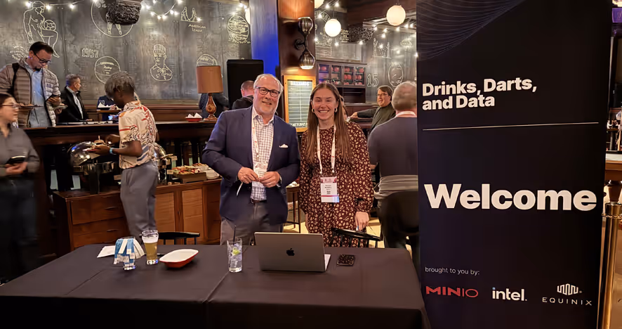 Drinks, Darts, and Data event with two people at a conference booth