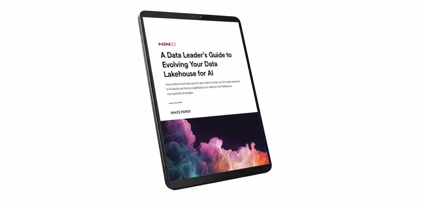 Tablet displaying a white paper titled 'A Data Leader's Guide to Evolving Your Data Lakehouse for AI' with colorful cloud graphics at the bottom.