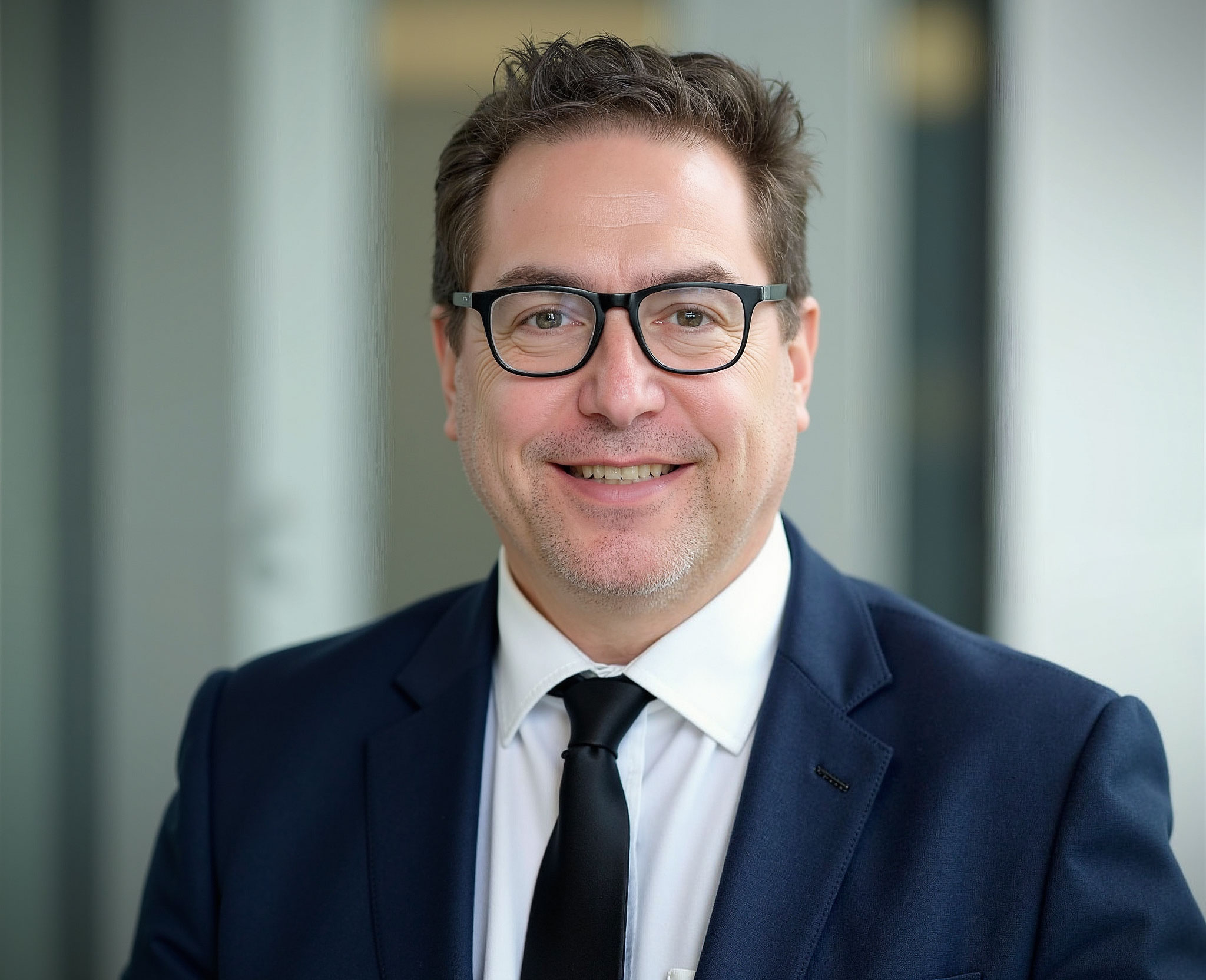 A headshot of Derek Eisenberg