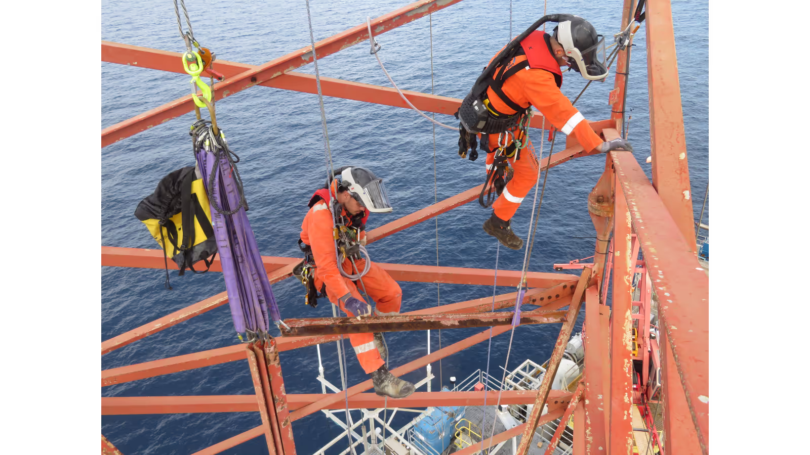 Rope access technician equipped with respiratory gear performs precision cutting, ensuring safe and efficient mechanical works at height during flare removal project.