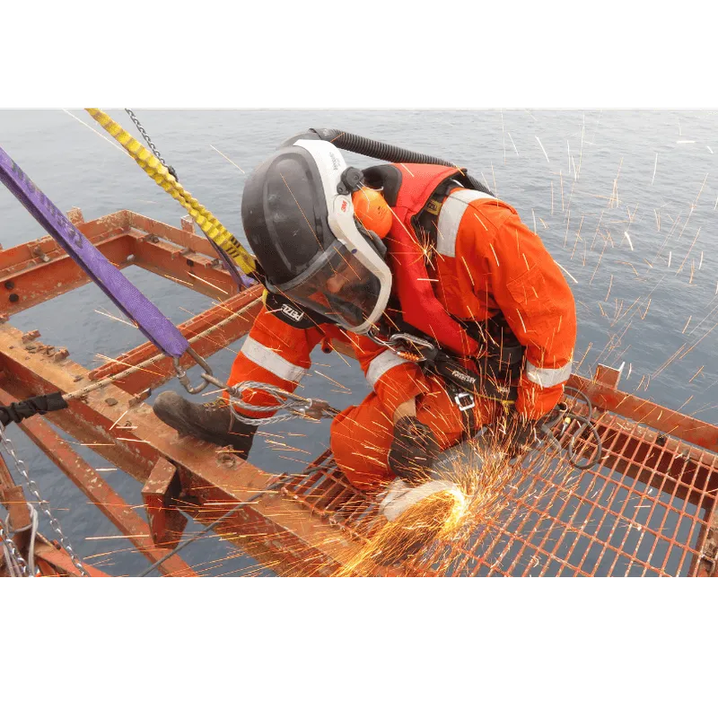 Technician wearing respiratory equipment cuts steel, ensuring safety and precision in the decommissioning process.