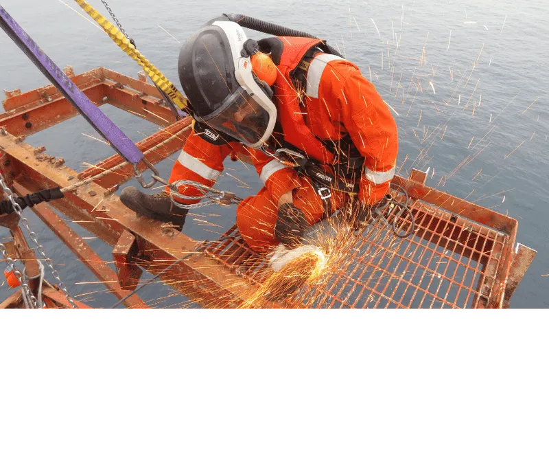 Technician with rope access qualifications welding structural components to ensure the integrity of the offshore asset.