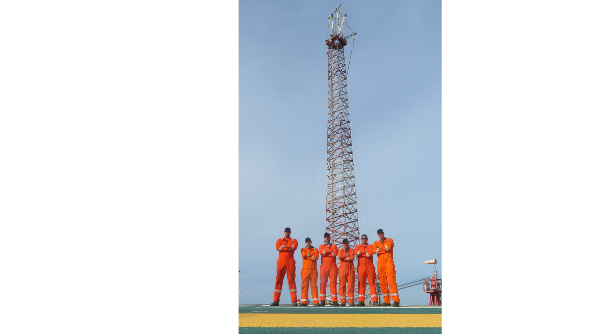 Crew poses before flare tower removal, poised to alter the skyline above GC-19 Boxer platform, marking a transformative endeavor.
