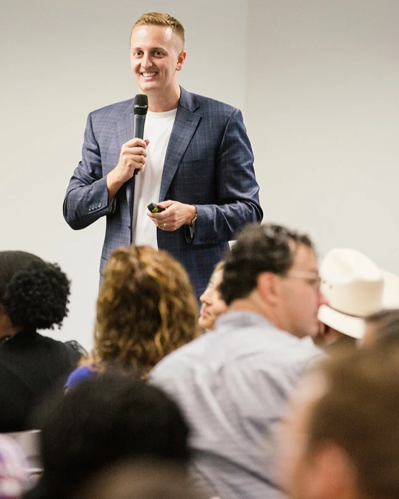 Matt Tresidder speak to audience in conference room