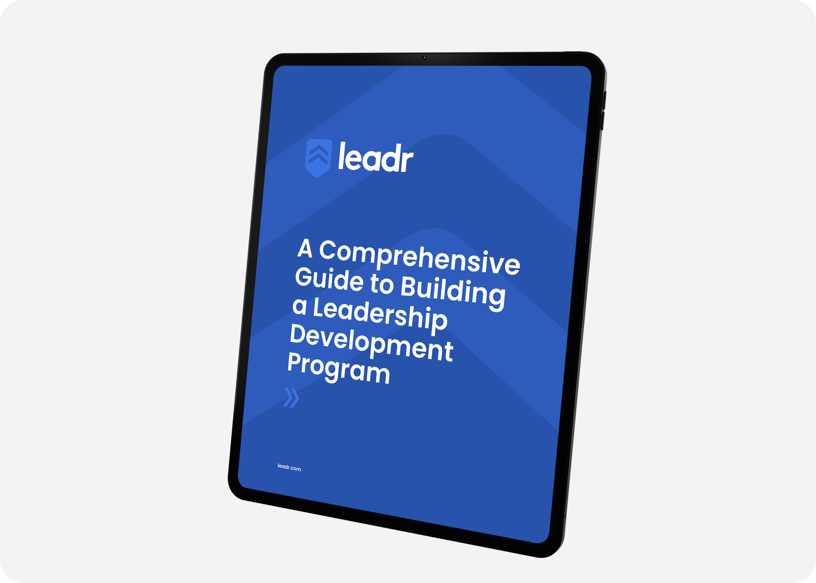 Tablet displaying Leadr guide on building a leadership development program.