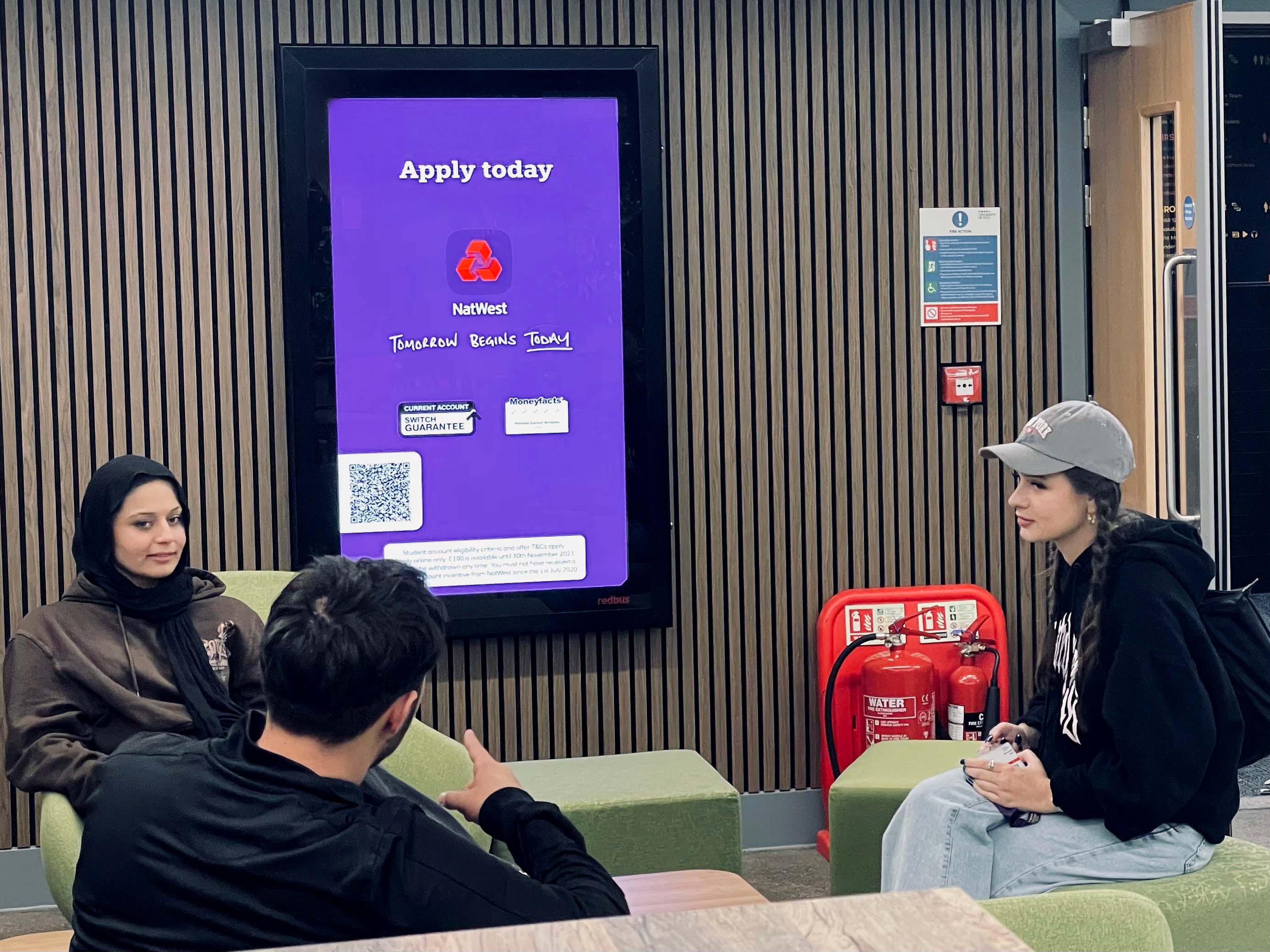 Students in front of DOOH screen