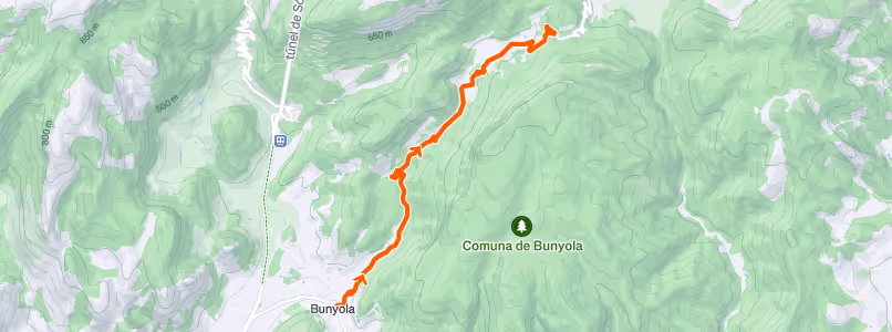Topographic map showing a hiking trail marked in orange starting from Bunyola and ascending northeast into mountainous terrain near Comuna de Bunyola.