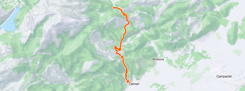 Topographic map showing a hiking trail marked in orange running between Calimari and an unnamed northern point, with surrounding green terrain and nearby locations Binibona and Campanet.