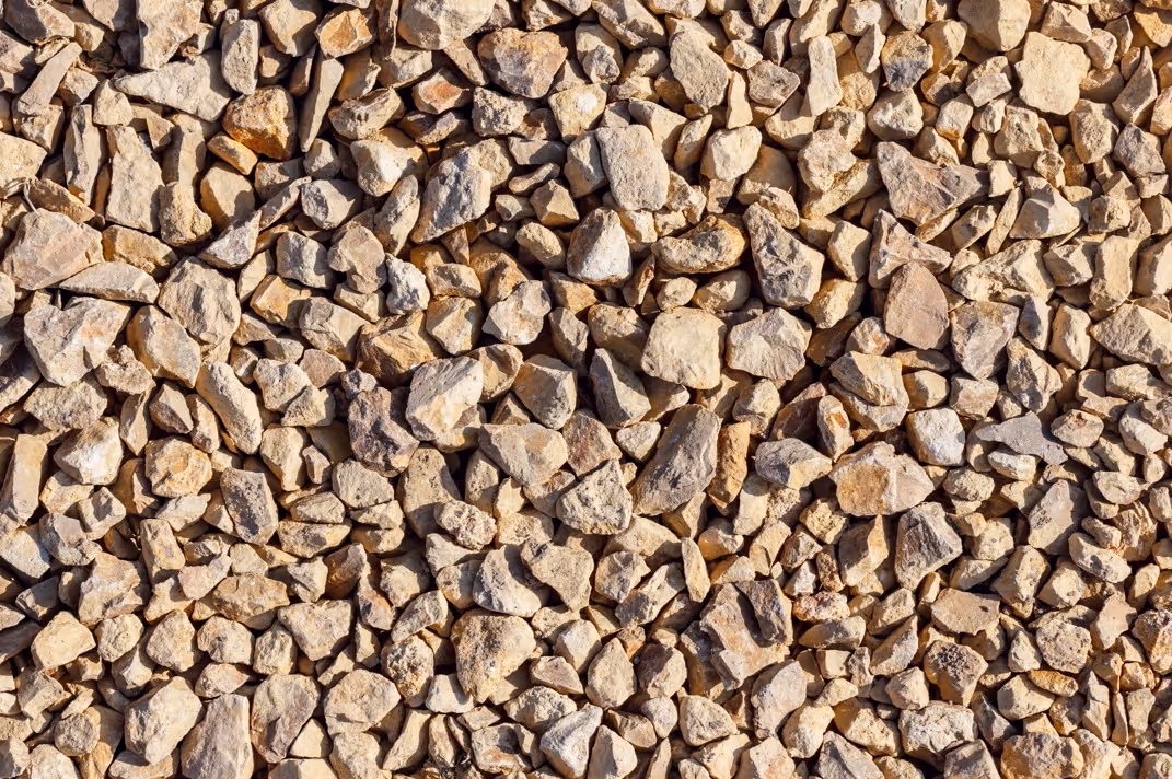 Brown crushed stone aggregate materials for construction hauling and heavy equipment transportation services