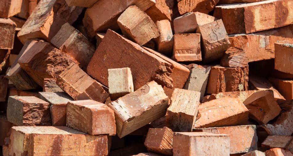 Red construction and demolition bricks for building material hauling and waste removal transportation services