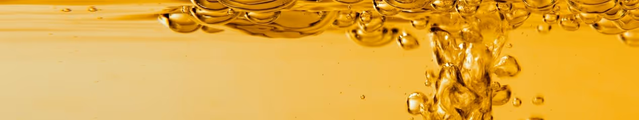 Golden refined petroleum oil with bubbles for liquid bulk hauling and chemical transportation services