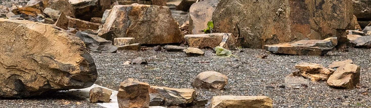 Mixed stone and concrete debris from landslide for emergency hauling and disaster cleanup transportation services