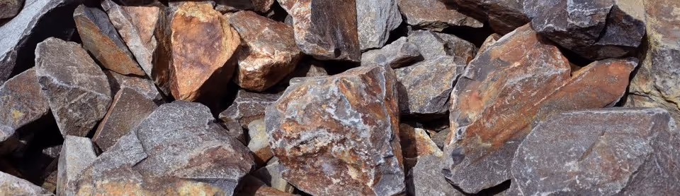 Brown and rust colored rock excavation material for quarry hauling and mining transportation services