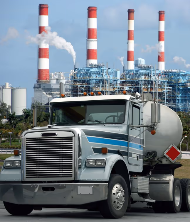 Tanker truck near industrial plant for commercial chemical and bulk liquid transport services