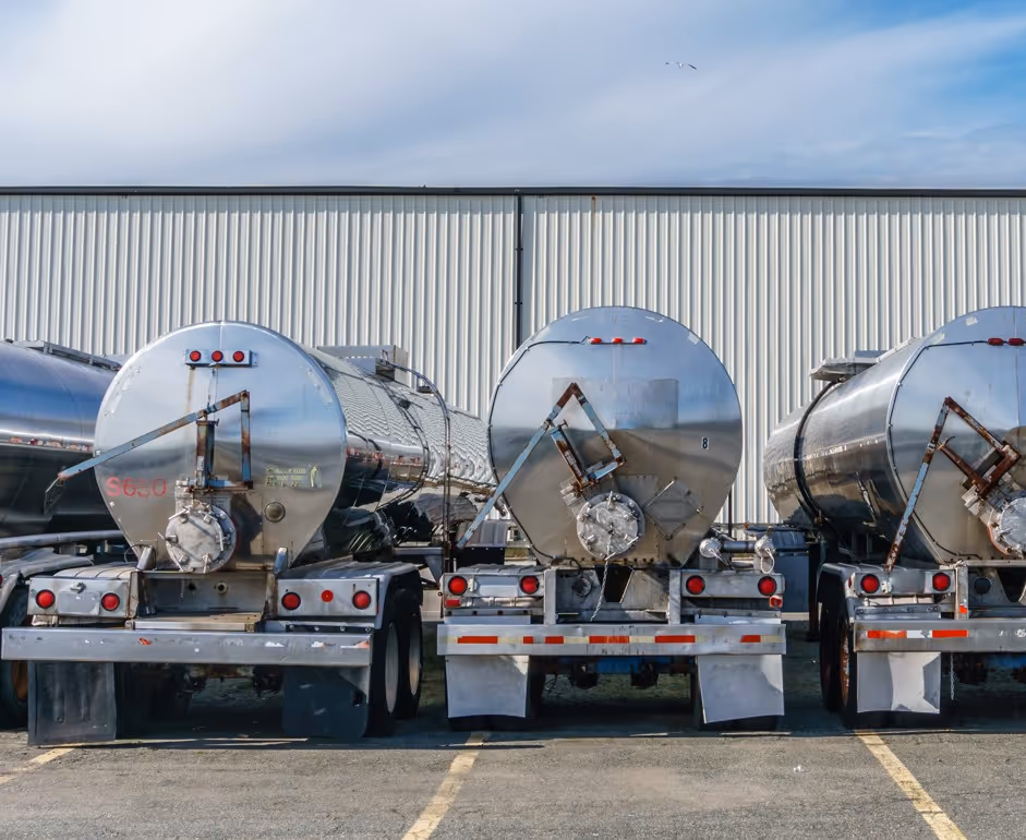 Multiple polished aluminum tanker trailers parked at facility for bulk liquid transport fleet