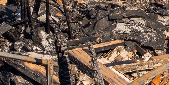 Fire damaged wood, metal and debris requiring emergency commercial hauling and hazardous material removal