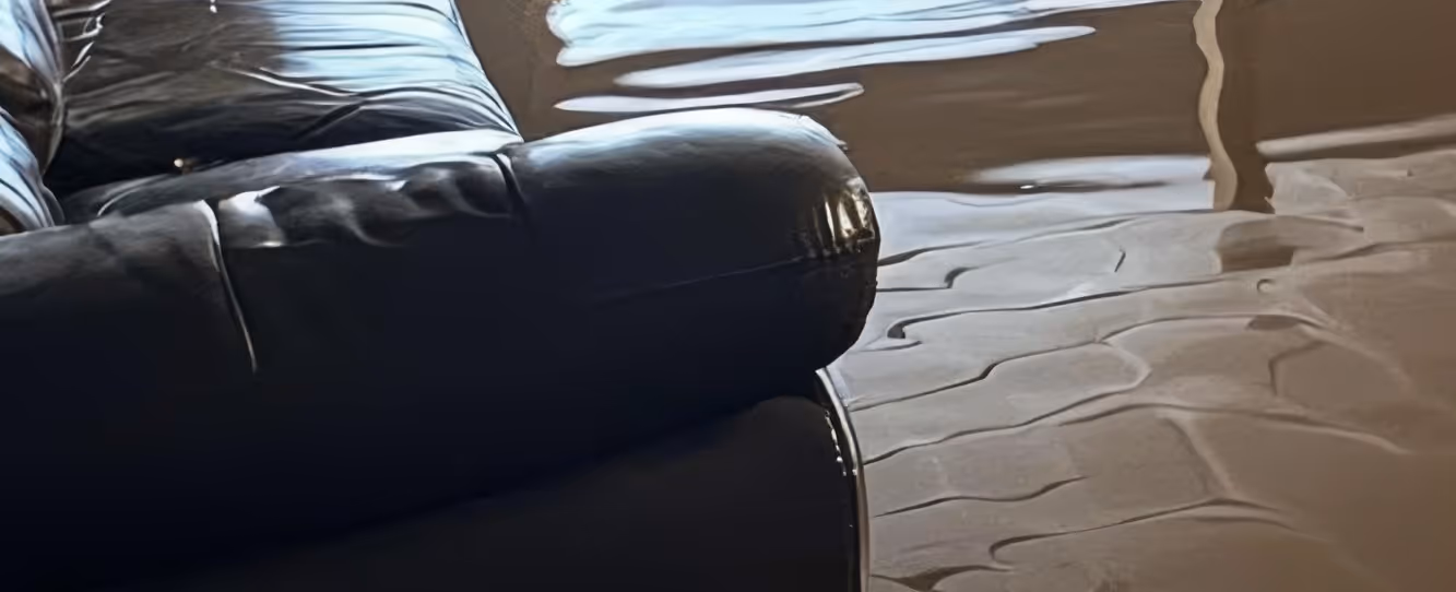 Water damaged furniture and belongings from flooding requiring emergency commercial hauling and contaminated material removal