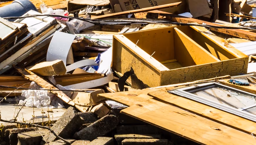 Mixed wood debris, furniture and building materials from hurricane damage requiring emergency commercial hauling and cleanup