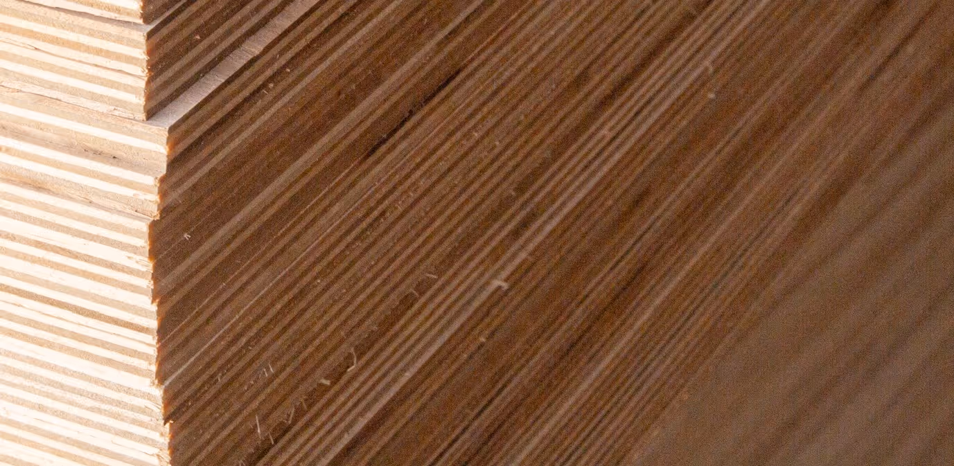 Stacked plywood sheets and engineered lumber products requiring specialized forestry product transport services