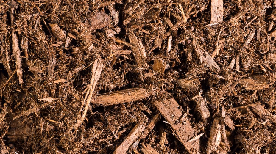 Natural wood mulch and decomposed organic matter for landscaping requiring forestry product transport and bulk mulch delivery