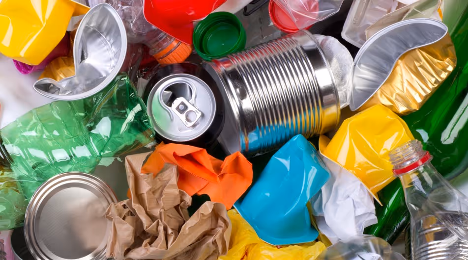 Mixed recyclable materials including plastic bottles, cans and paper requiring sorted recycling material hauling services