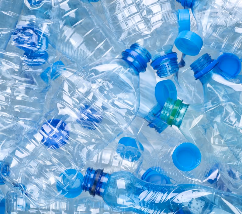 Clear PET plastic bottles and containers for recycling requiring specialized plastic recycling material hauling services