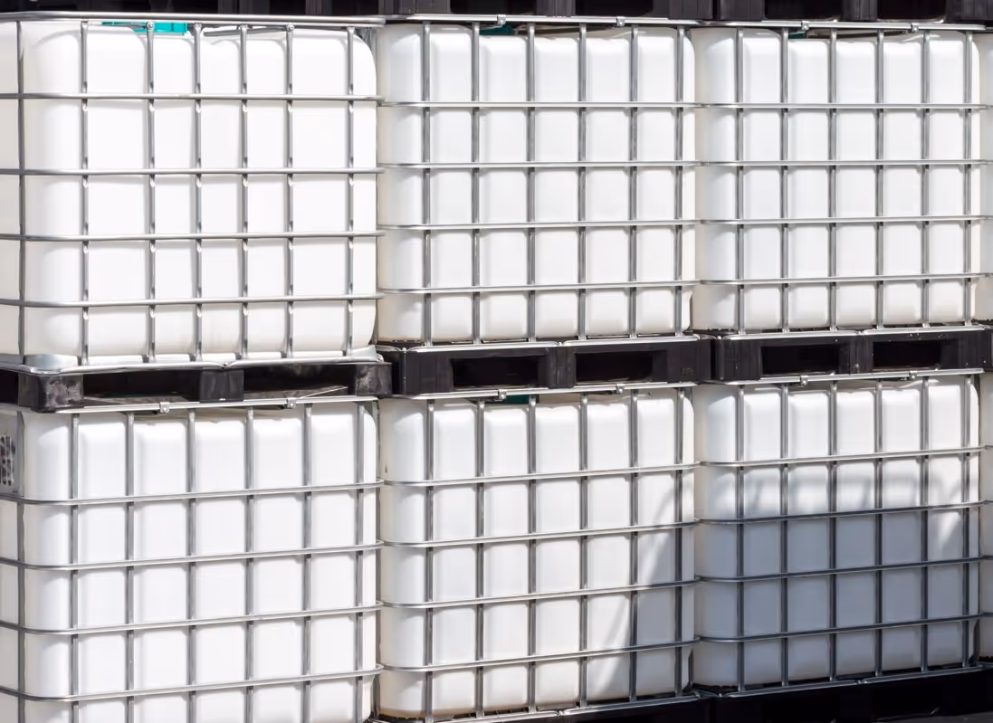 Industrial IBC totes and bulk liquid containers requiring specialized commercial container hauling and chemical transport