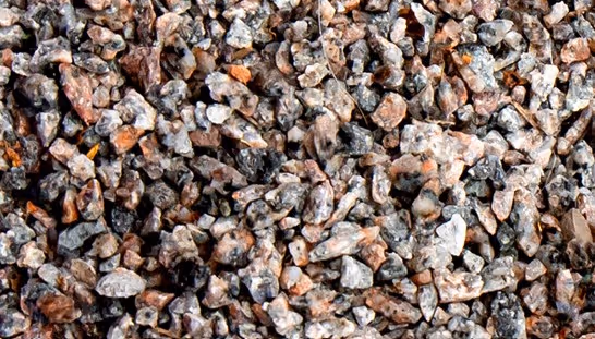 Mixed winter abrasive materials for commercial traction and slip prevention services